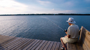 A senior man fishing alone.